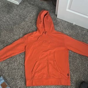 Van’s orange sweatshirt